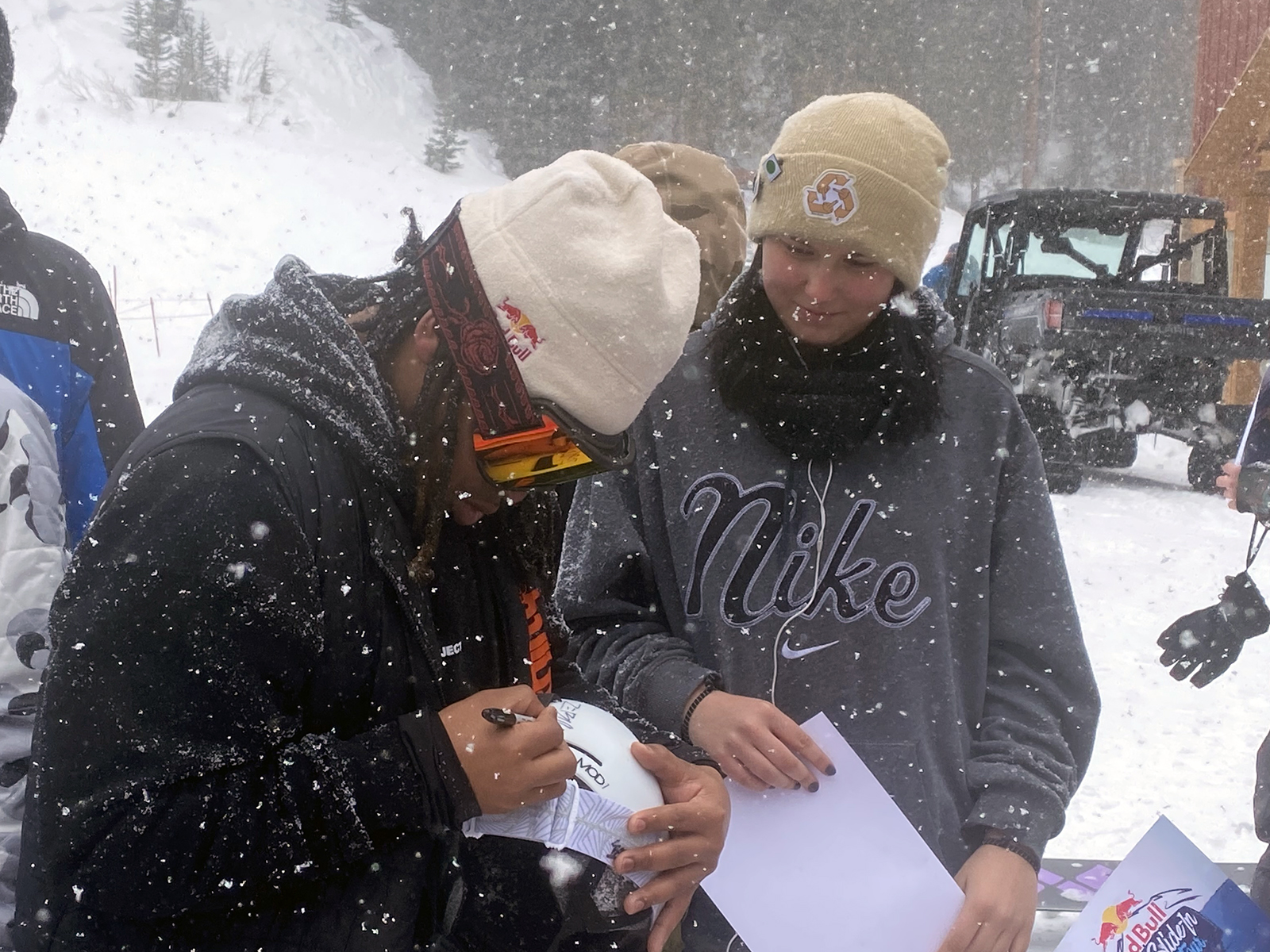 Zeb Powell signs an autograph for Lili Nielsen at the Red Bull Slide-In Tour at Copper Mountain.